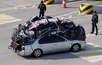 Mobil dengan penuh muatan barang produksi memasuki kawasan zona demiliterisasi, karantina dan bea cukai.