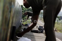 Anggota Satpol PP membersihkan coretan-coretan dingding di sepanjang BKT.