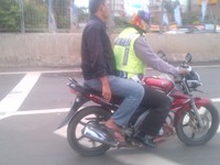Foto diambil pada 31 Mei 2013 pukul 10.45 di tol JORR 2 dekat Taman Kencana Cengkareng. Pak Polisi ini kemungkinan ingin cepat melaksanakan tugasnya. (Foto pembaca).