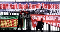 Buruh memasang spanduk menolak kenaikan harga BBM di pintu gerbang DPR. Lamhot Aritonang/detikFoto.