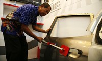 Sujak Widodo memperagakan mengembalikan bodi mobil yang penyok ke bentuk semula. (dok Astra).