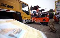 Seorang pengunjung melintas di depan booth GM Tractors di Arena JIEXPO.