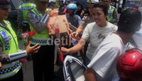 Selain helm, polisi juga membagikan bungar mawar.
