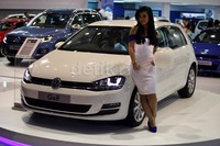 Seorang model berpose dengan Volkswagen (VW) Golf di IIMS 2013.