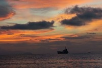 Sunset bisa dinikmati tanpa ada halangan apapun ke cakrawala. Panorama kapal-kapal yang hilir mudik di batas laut dan langit juga pantas Anda abadikan dalam kamera (Ropesta/detikTravel)