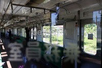 Dua orang pekerja membersihkan interior kereta.