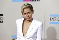 Miley Cyrus tampil mengenakan pantsuit seksi berwarna putih dari Versus Versace. REUTERS/Mario Anzuoni.