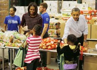Presiden AS Barrack Obama dan Ibu Negara Michelle Obama (kiri) tersenyum kepada pengunjung di pusat perbelanjaan di Washington, akhir pekan ini.( REUTERS/Larry Downing). Tampak keduanya bebas berbelanja tanpa dikawal petugas protokel screet service secara ketat.