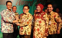 Menteri Tenaga Kerja dan Transmigrasi Muhaimin Iskandar memberikan piala Makarti Nayotama kepada Wakil Gubernur Jawa Timur Saifullah Yusuf di Hotel Bidakara, Jakarta, Selasa (3/12/2013).