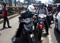 Para pengendara ini masuk jalur Busway ketika petugas membukakan portal untuk bus TransJ.