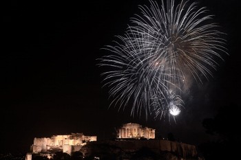 Perayaan tahun baru Yunani, Athena. Kembang api meledak di atas kuil kuno Parthenon di puncak bukit Acropolis. (kredit foto: Aris Messinis/AFP/Getty Images)