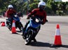 Dua pengendara berusaha melewati trek berkelok-kelok dalam test drive di pelataran parkir gedung JIExpo, Jakarta Pusat.