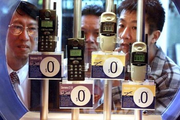 Beberapa pengunjung melihat lihat beberapa model ponsel terbaru di Hong Kong pada tahun 1999.