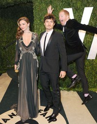 Aktor komedi Jesse Tyler Ferguson begitu bersemangat hingga harus melompat di belakang Miranda Kerr dan Orlando Bloom. Foto ini diambil tahun lalu saat perhelatan Vanity Fair Oscar party di Sunset Tower, Hollywood Barat berlangsung.