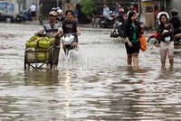     Sejumlah warga melintas di jalanan yang terendam banjir.