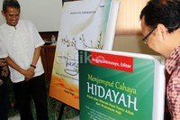 Anggito membuka selubung tanda peluncuran buku karyanya, Jumat (31/1/2014).
