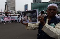 Salah seorang anggota FPI membawa sebuah kertas yang bergambar karikatur SBY yang mengatakan, Dengan Rahmat Tuhan Yang Maha Esa,minuman Beralkohol boleh beredar kembali.