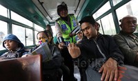 Seorang Polwan juga membagikan peta mudik kepada penumpang angkutan umum.
