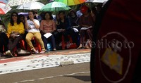 Sejumlah umat kristiani yang sedang beribadah tampak menggunakan payung untuk menghalau panas yang menyengat siang ini.