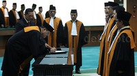 Hatta Ali menandatangani berita acara pelantikan.