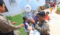 Anggota Satpol PP ikut membantu warga memindahkan barang-barang mereka.