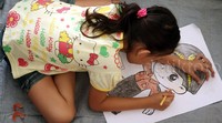 Seorang anak serius mewarnai.