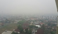 Pemandangan dari atas, terlihat rumah-rumah penduduk Pekanbaru dikepung asap pekat.