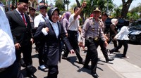 Risma dan Whisnu berjalan dengan diiringi pendukungnya.