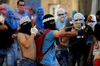 Pemuda Palestina dengan ketapel melempari tentara Israel dengan batu. REUTERS/Ammar Awad.