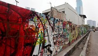 Tembok di sepanjang di Jalan KH Mas Mansyur, Tanah Abang, Jakarta Pusat, dipenuhi oleh grafiti.