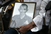 Seorang pendemo membawa foto suaminya saat masih berdinas.