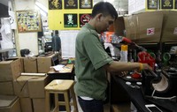 Seorang pekerja sedang malakukan pembiatan pin.