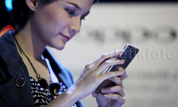 Seorang model mengutak atik Oppo R7s. R7s dilengkapi prosesor delapan inti Snapdragon 615, yang dipadu dengan kapasitas RAM sebesar 4 GB! Kombinasi ini bikin R7s punya performa terkencang di serinya.