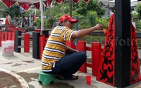 Seorang warga melakukan pengecatan. Pool/Lamhot Aritonang/detikFoto.