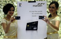 Dua orang model menunjukkan kartu kredit Mandiri Mastercard World Elite.