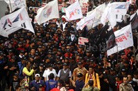 Massa membawa berbagai bendera dan beberapa terlihat membawa topeng wajah BW.