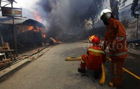 Pantauan di lapangan petugas pemadam kebakaran masih menyemprot sisa-sisa kebakaran.