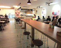 Coffee World berkonsep terbuka dengan area bersantap luas. Interior restoran didominasi furnitur kayu dan dinding putih dengan lukisan pop-art aneka warna.