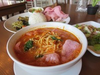 Mie rebus berkuah oranye ini memiliki tekstur yang kental dengan isian sayuran, suwiran ayam hingga mie yang lembut mulur.