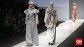 Tak sekadar menampilkan busana hijab berdesain minimalis, Ria Miranda juga memamerkan detail rumit di beberapa koleksinya, seperti busana abu-abu dengan aksen pada pangkal lengan hingga pinggang, juga simpul hijab di bagian punggung.