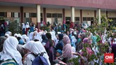 Para orangtua bersama anak-anak mereka terlihat berkerumun di lapangan Sekolah Darul Ilmi. Melalui Permendikbud 18/2016, pemerintah menegaskan tidak ada lagi pelaksanaan Masa Orientasi Siswa (MOS), digantikan dengan Pengenalan Lingkungan Sekolah. (CNN Indonesia/Andry Novelino)