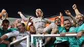 Nico Rosberg saat merayakan gelar bersama timnya. Bagi Rosberg, kemenangan ini adalah hasil manis setelah ia hanya mampu jadi runner up di musim 2014 dan 2015. (AFP PHOTO / Andrej ISAKOVIC)