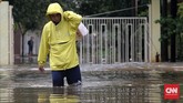 Banjir setinggi lutut orang dewasa juga melanda Perumahan Timur Emas, Bekasi Selatan, Selasa (21/2). Cukup banyak warga di perumahan tersebut yang menerjang banjir. Di antara mereka ada yang membawa barang dengan memposisikan di belakang punggung agar tak terkena air. (CNN Indonesia/Safir Makki)