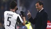 Gelandang Miralem Pijanic (kiri) mendapat instruksi dari pelatih Juventus Massimilliano Allegri di pinggir lapangan Stadion Juventus. I Bianconeri gagal membobol gawang Napoli di babak pertama. (AFP PHOTO / Marco BERTORELLO)