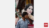 Poster iklan menjadi salah satu bagian elemen fotografi jalanan. Menunggu orang lewat dengan gestur tangan yang sama dengan gestur tangan poster perempuan membentuk kesan kesamaan dalam fotografi jalanan.