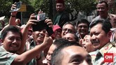 Djarot menyempatkan diri untuk turun dari kereta kencana yang ditumpanginya untuk sekedar menuruti bermintaan berswafoto dengan warga. (CNN Indonesia/Andry Novelino)