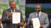 Kenyatta (kiri) bersama wakilnya William Ruto (kanan) memenangkan pemilu dengan suara 98 persen. (AFP Photo/Tony Karumba)