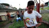 Seorang warga Myanmar mengenakan kaus peringatan lawatan Paus Fransiskus ke Myanmar di kamp orang-orang yang bepergian dari Kachin ke Stadion Sepak Bola Bogyoke Aung San, sambil menanti misa Paus Fransiskus di Yangon, Selasa (28/11). (REUTERS/Jorge Silva)