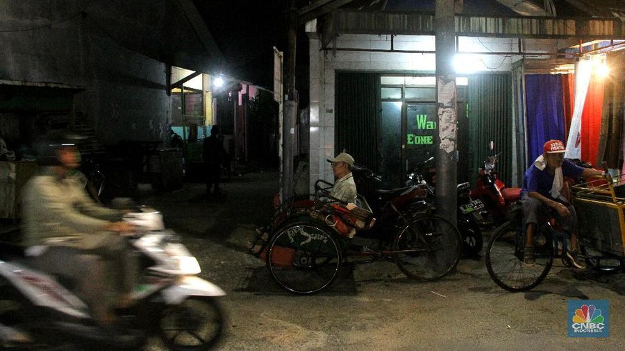 Seorang pengayuh becak mengangkut penumpang di kawasan Pasar Warakas, Tanjung Priok, Jakarta, Selasa (16/1/2018) malam. Gubernur DKI Jakarta Anies Baswedan mengatakan untuk merealisasikan wacana pengoperasian becak akan disusun lebih dulu aturannya. Dalam aturan yang akan dibuat, tertuang ketentuan seperti zona pengoperasian becak, sampai sanksi bila terjadi pelanggaran.