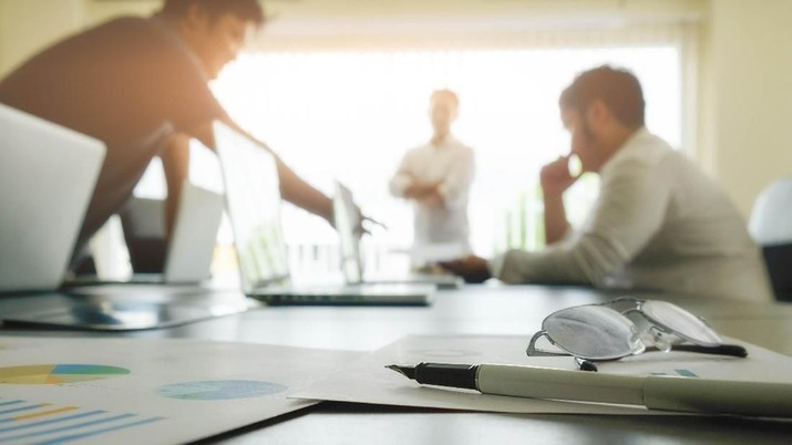 Business adviser analyzing financial Business adviser analyzing financial figures denoting the progress in the work of the company.